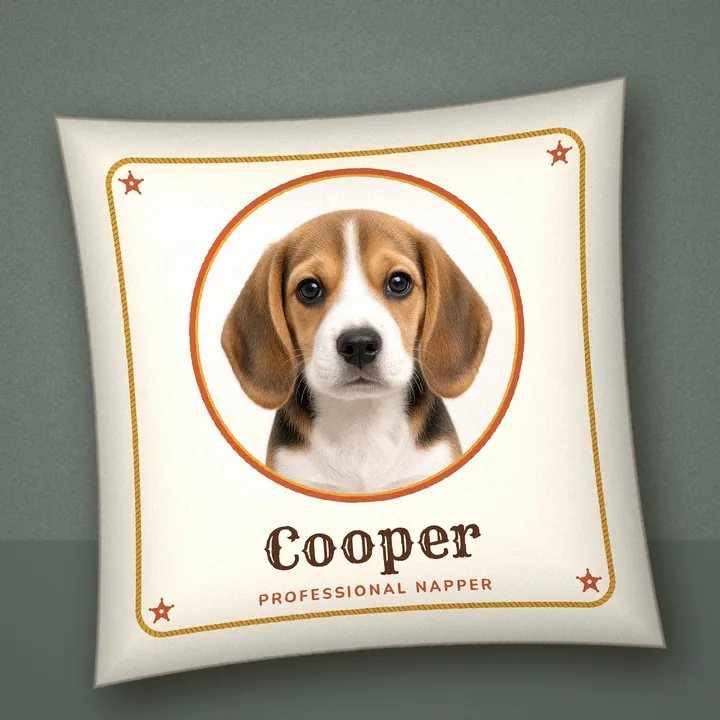 Square throw pillow on a sofa with a beagle photo in a round frame, reading Cooper, Professional Napper